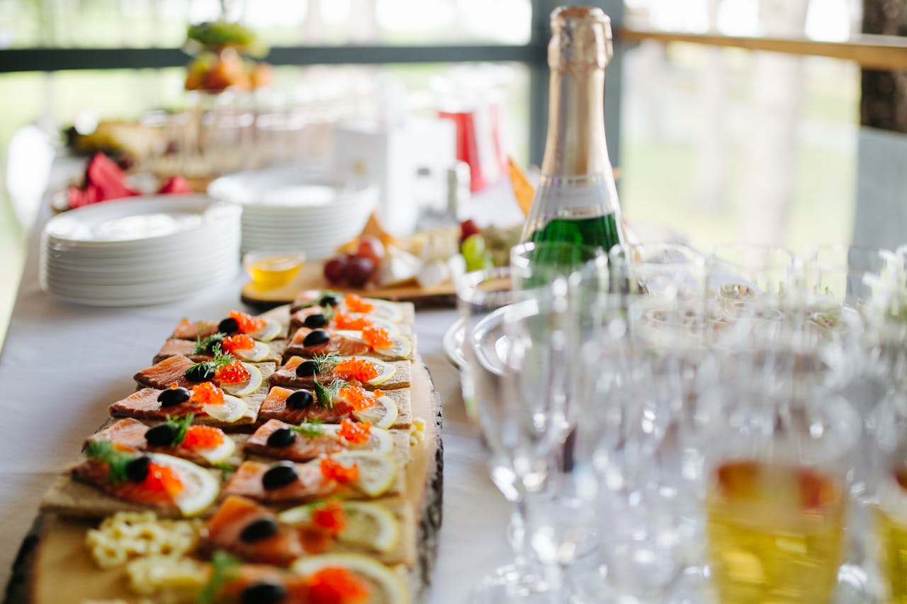 portfolio-06 Platter of gourmet appetizers served with champagne for a stylish event.