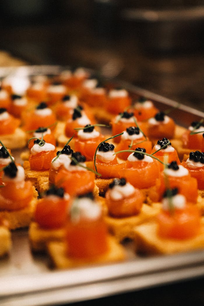 creative-approach-img Close-up of gourmet canapés topped with salmon and caviar, perfect for luxury events.